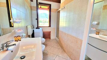 Ein modernes Badezimmer mit Waschbecken, Toilette und Duschbereich.