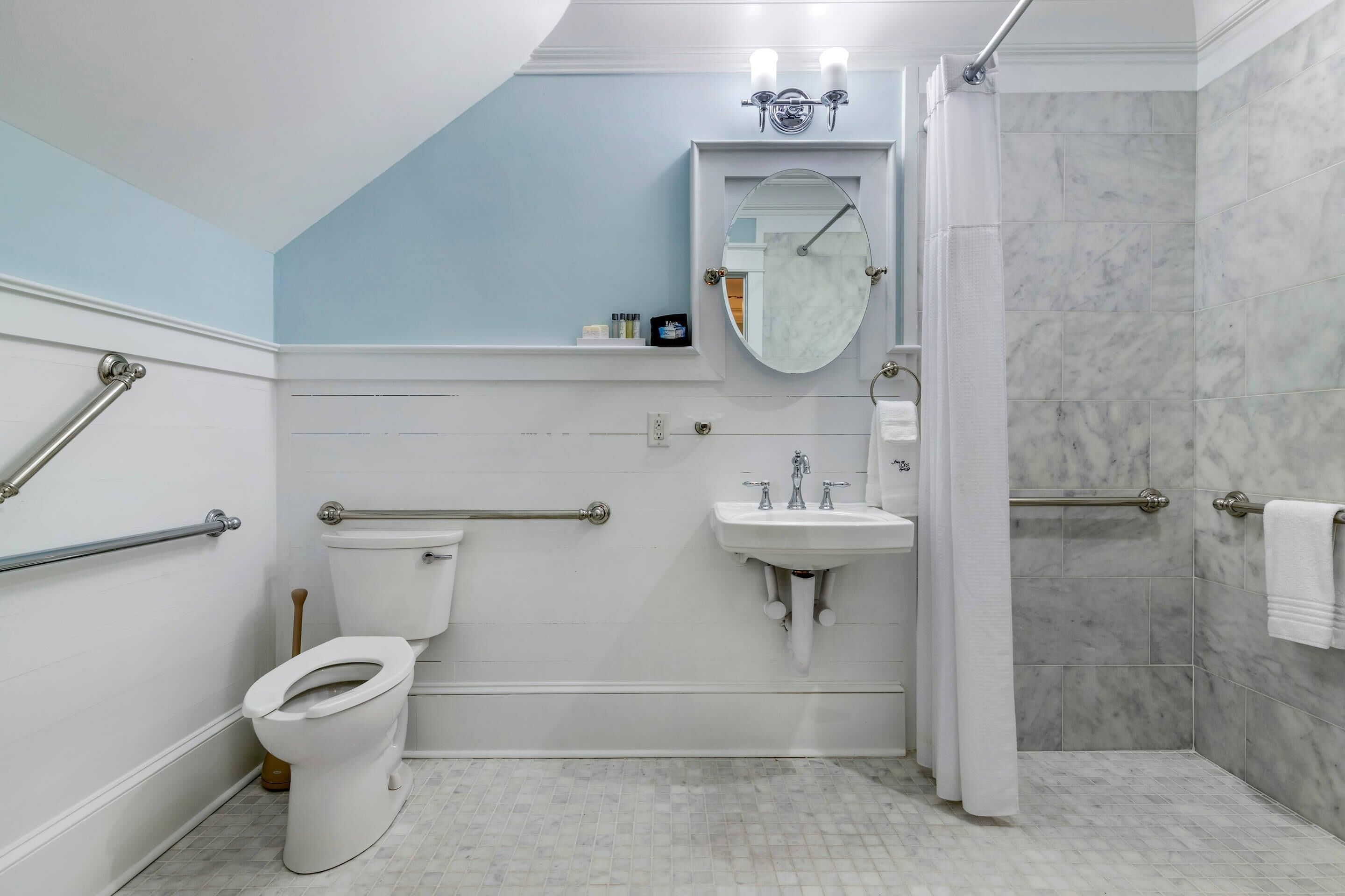 A bathroom with a toilet, sink, and shower.