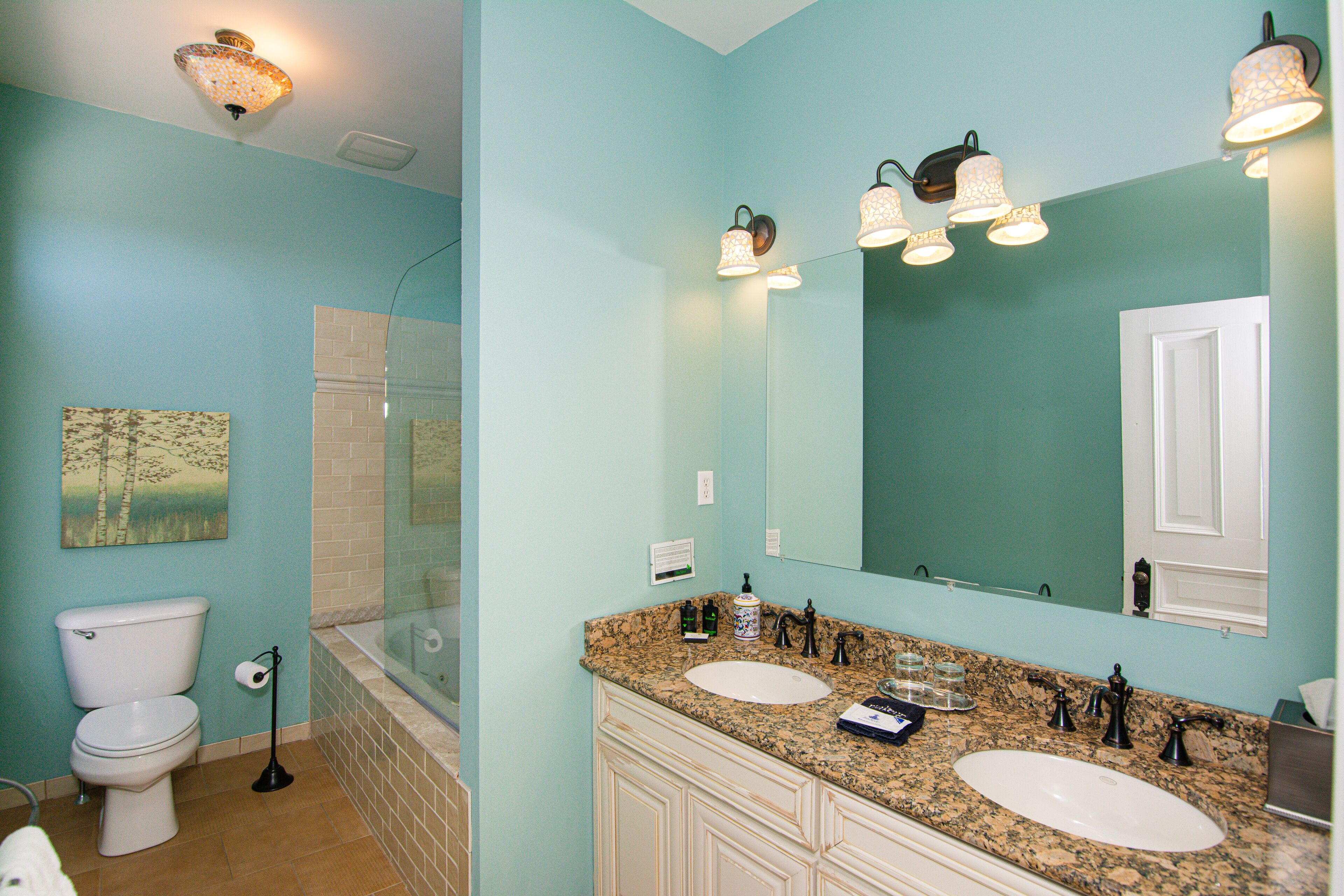 A bathroom with a toilet, sink, and bathtub.