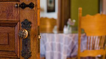 A wooden door with a brass handle and a decorative knocker.