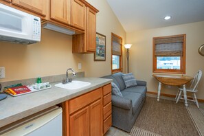 Queen/Jacuzzi Suite 23 (End Unit/Deck Water View) | Living area | Flat-screen TV - Bridge Inn (Michigan City)