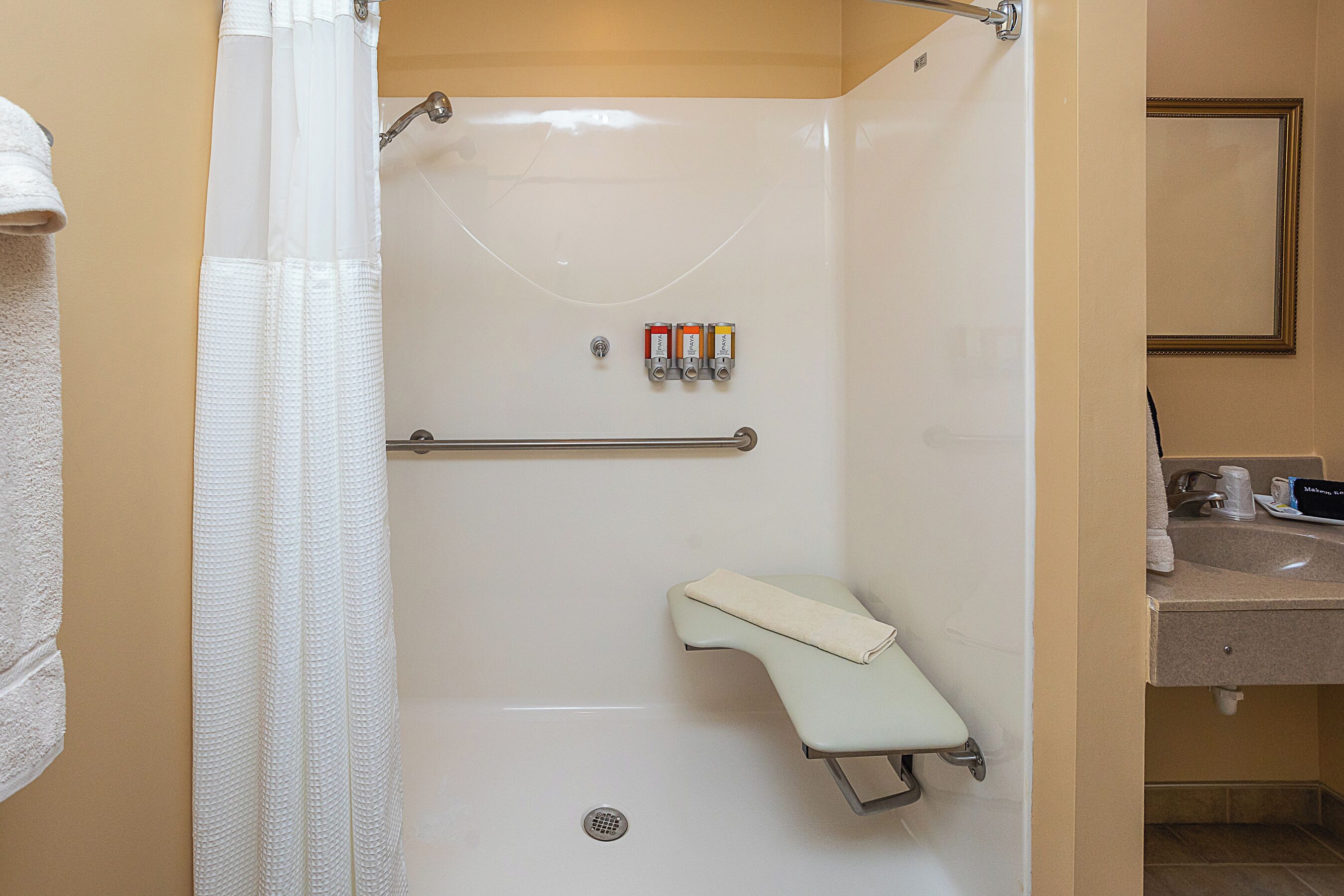 A bathroom with a shower, a toilet, and a sink.