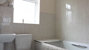 A bathroom with a toilet, sink, and bathtub. - Leysdown Chalet 28 (Sheerness)