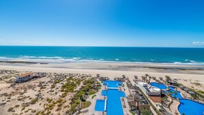 A resort with multiple swimming pools, beach access, and a view of the ocean. - Encanto Living 1103 -3BR by Kivoya (Puerto Peñasco)