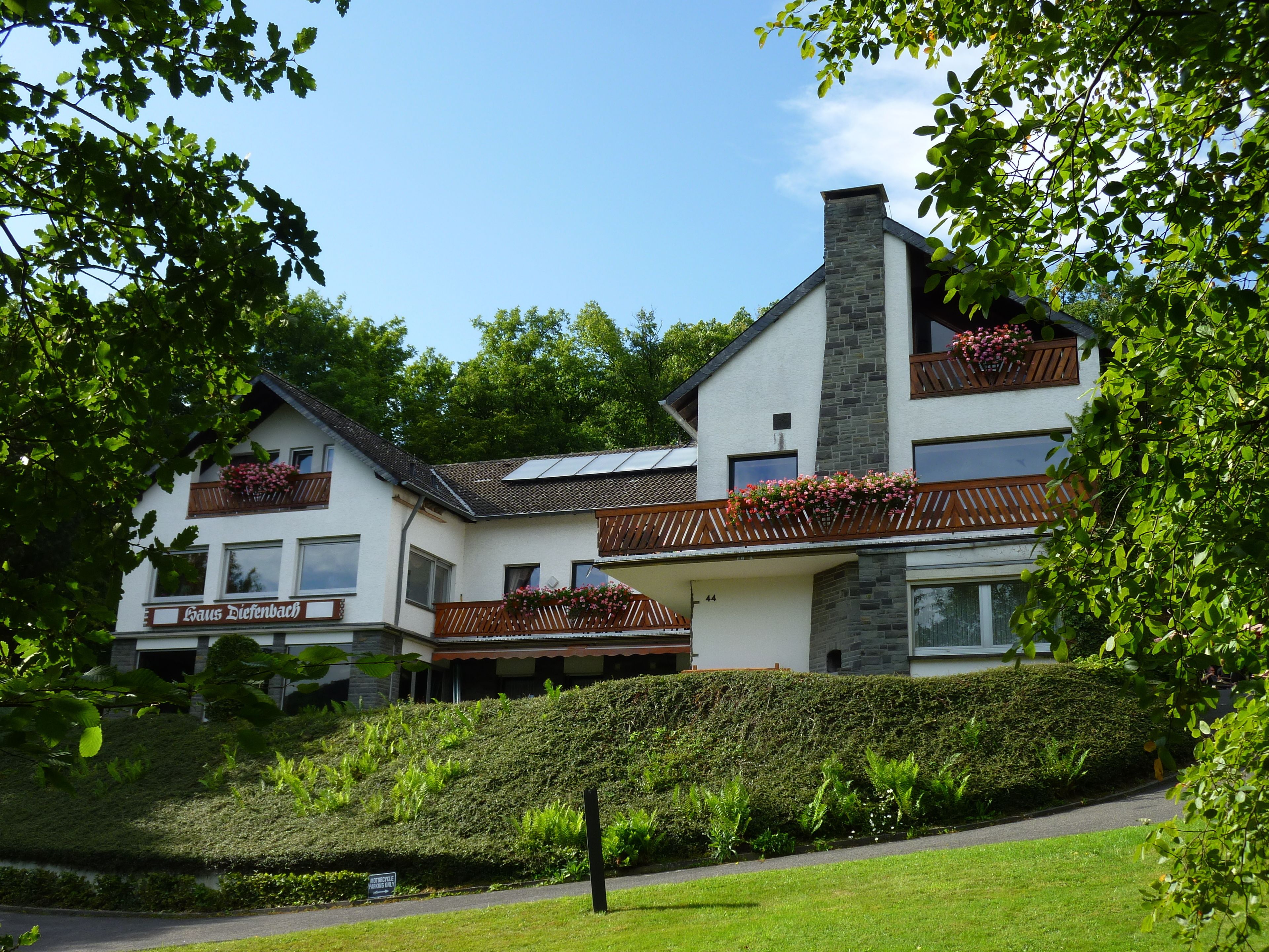 A two-story building with a sign reading "Haus Diefenbach".