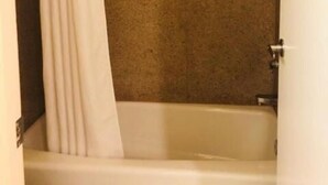 A bathroom with a bathtub, a shower, and a curtain. - Bayshore Inn (San Jose)