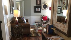 A cozy living room with a brown sofa, a glass coffee table, and a patterned rug. - Clean, Light, Centrally Located, Quiet Neighborhood (Amarillo)