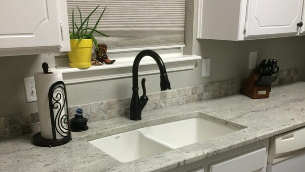 A kitchen with a white countertop, a black faucet, and a window with blinds. - Clean, Light, Centrally Located, Quiet Neighborhood (Amarillo)