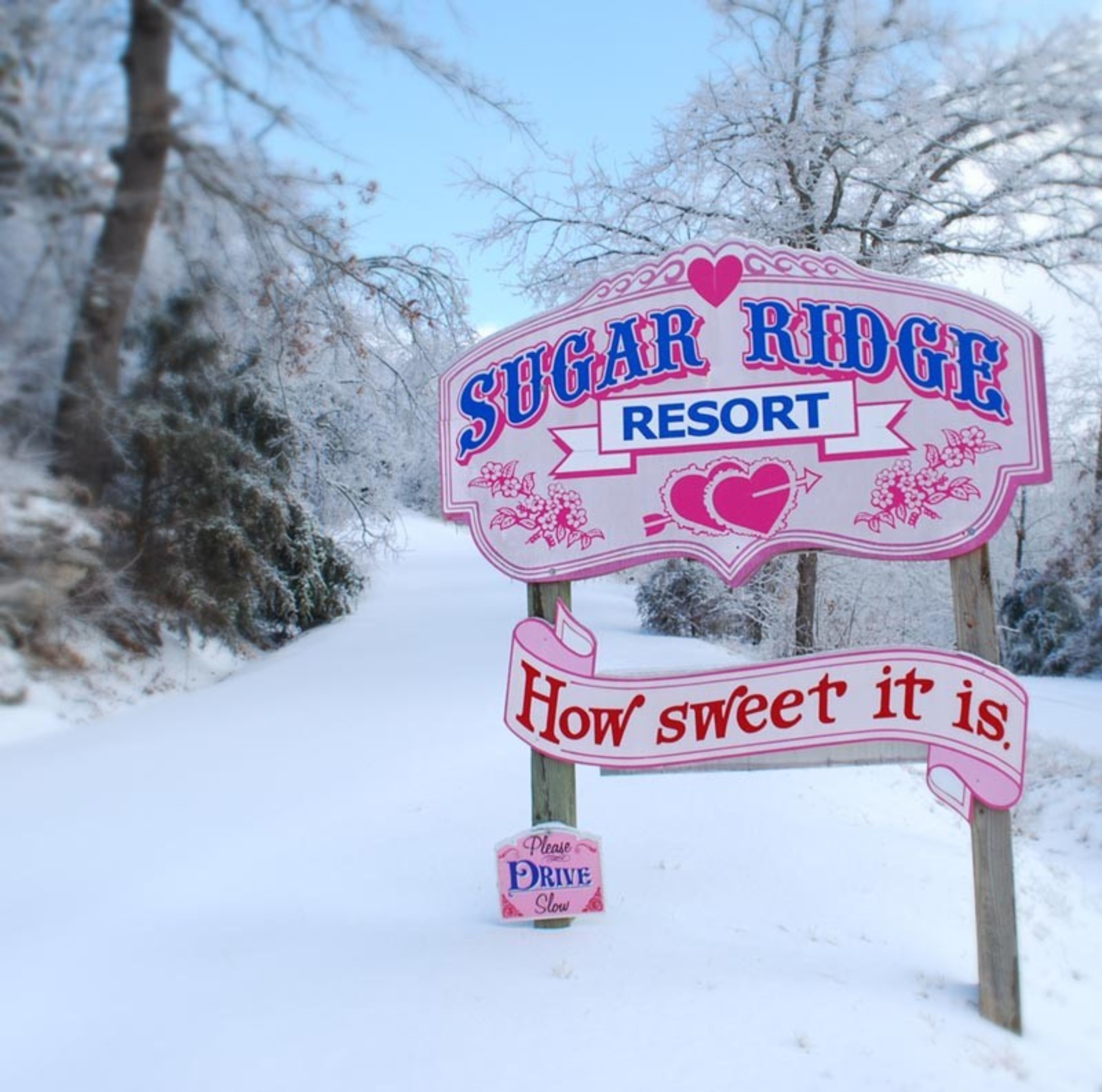 A sign for Sugar Ridge Resort with a heart and the phrase "How sweet it is."