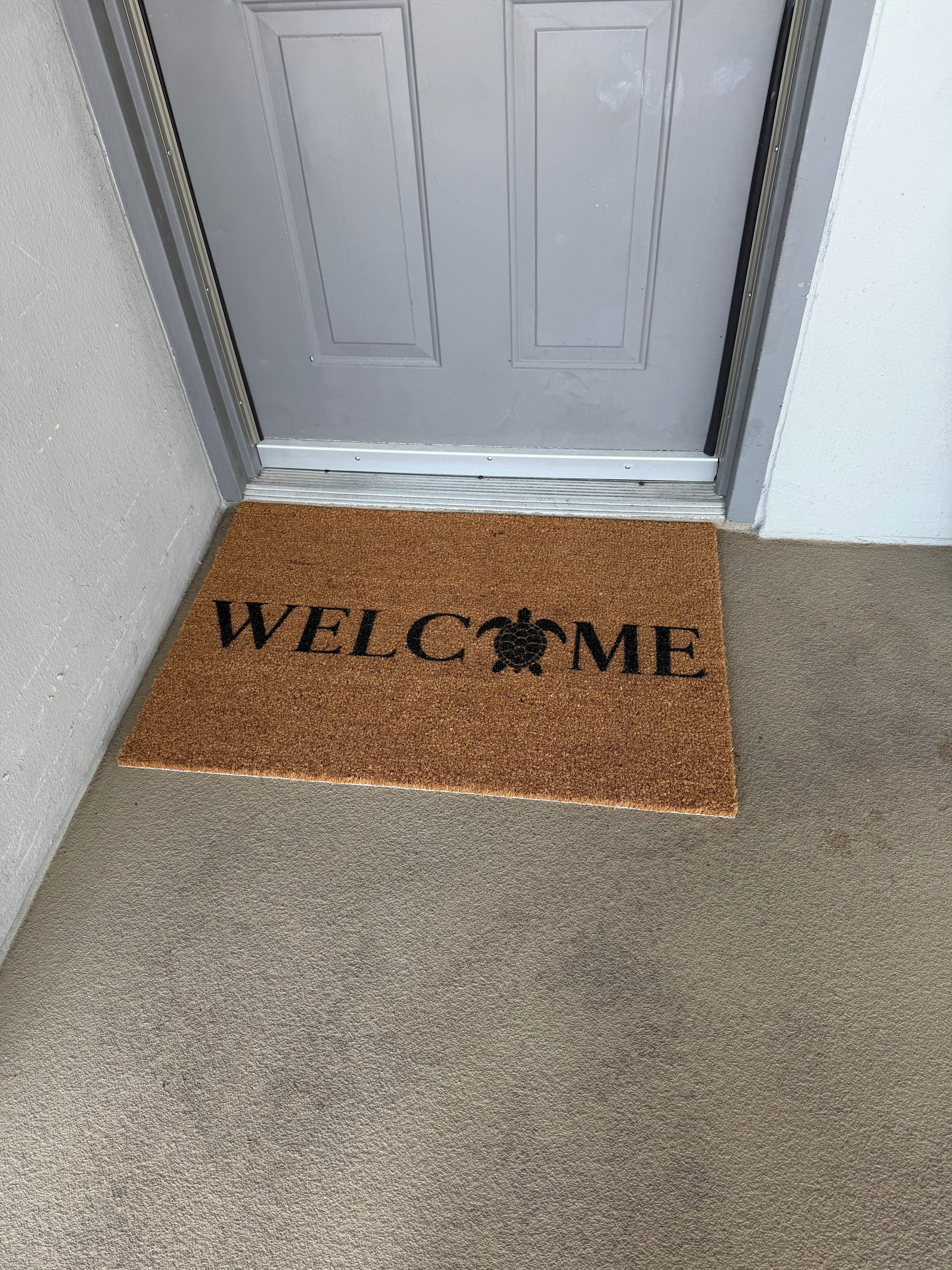 A doormat with the words 'WELCOME' and a symbol of a person.