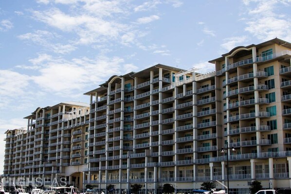 A multi-story hotel with balconies, a flat roof, and a clear sky.