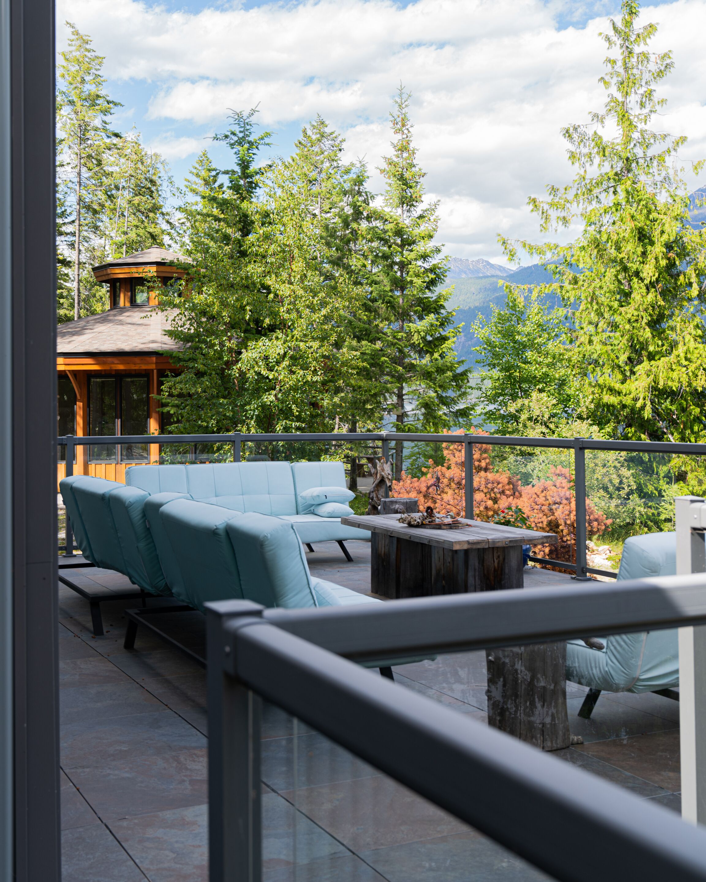 A balcony with a view of trees and mountains.