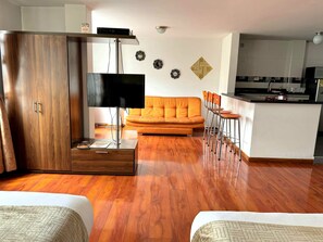 Aparta Estudio | Living area | 36-inch flat-screen TV with cable channels, TV - Aparta Hotel Oporto 83 (Bogotá)