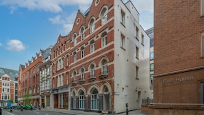 A historic building with arched windows and a brick facade. - Chancery Lane Apartments (London)