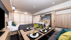 A modern hotel room with a dining area, a bed with a view, and a small kitchenette. - MIMARU Kyoto Shinmachi Sanjo (Kyoto)