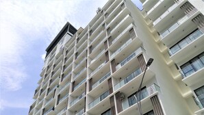 A multi-story residential building with balconies, large windows, and a modern architectural design. - ETM Midhill Comfy Studio Room (Genting Highlands)