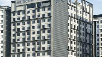 A multi-story hotel with a modern design, featuring a prominent 'W' logo on the facade.
