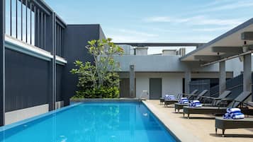 Outdoor pool, open 7:00 AM to 7:00 PM, pool umbrellas, pool loungers