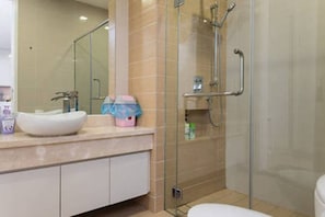 A modern bathroom with a glass-enclosed shower, a white sink, and a mirror. - Bangsar Camelia Homestay KL (Kuala Lumpur)
