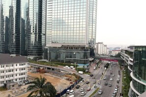 A modern urban area with high-rise buildings, a busy road, and a construction site. - Bangsar Camelia Homestay KL (Kuala Lumpur)