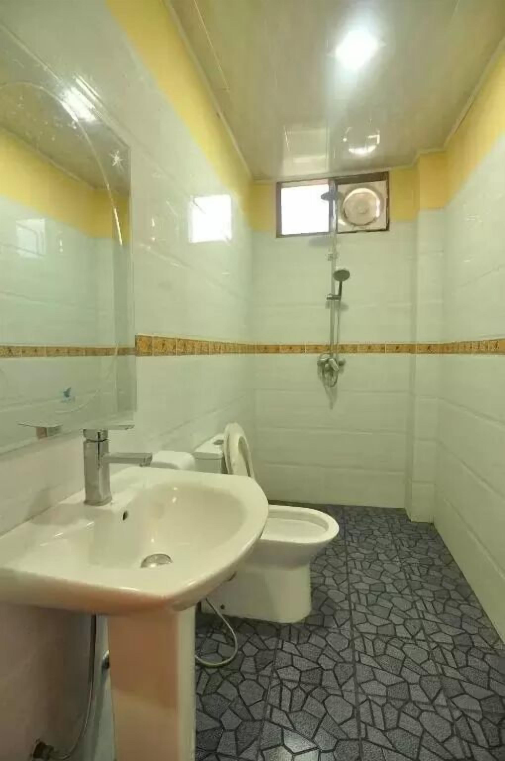 Ein Badezimmer mit Waschbecken, Toilette und Dusche.