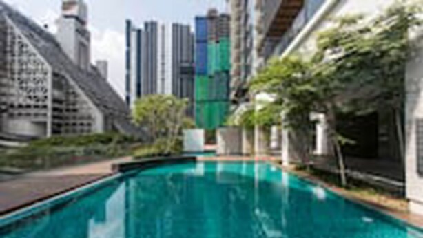 A swimming pool with a cityscape in the background. - Pipit Homestay at Element Ampang (Kuala Lumpur)