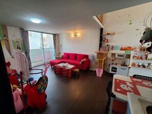 Family Quadruple Room | Living area | 42-inch flat-screen TV with digital channels, TV