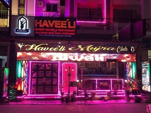 A brightly lit club with neon signage and a neon-lit entrance. - Haveeli Guesthouse and Mujra (Pattaya)