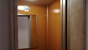 An elevator with wooden walls and a white door. - Venice Primavera Guesthouse  (Mestre)