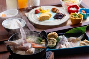 A dining table with various dishes including a hot pot, rice, and assorted side dishes. - Minato Koyado Awajishima (Minamiawaji)