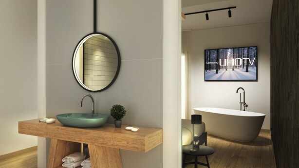 A modern bathroom with a wooden vanity, a round mirror, a sink, and a bathtub. - Meg Lifestyle Hotel (Riccione)