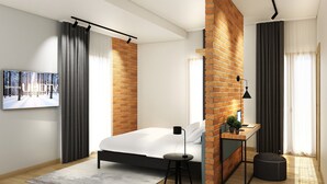 A modern bedroom with a brick accent wall, a bed, a desk with a computer, and a large window with curtains. - Meg Lifestyle Hotel (Riccione)