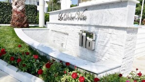 A stone sign with the name "La Dolce Vita" and the number "16" indicating a hotel or property. - Meg Lifestyle Hotel (Riccione)
