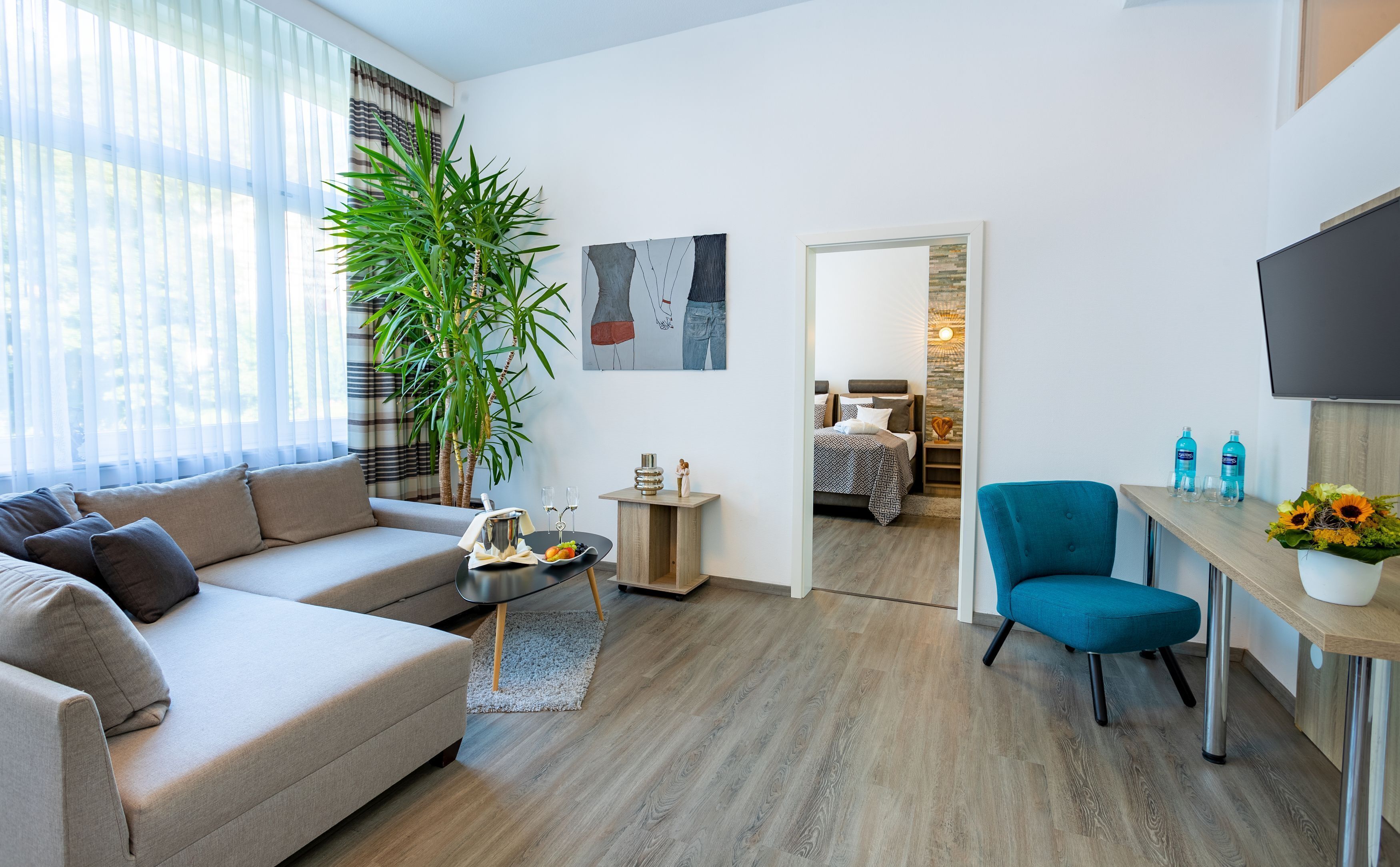 luxury suite | in-room safe, desk, blackout curtains, iron/ironing board