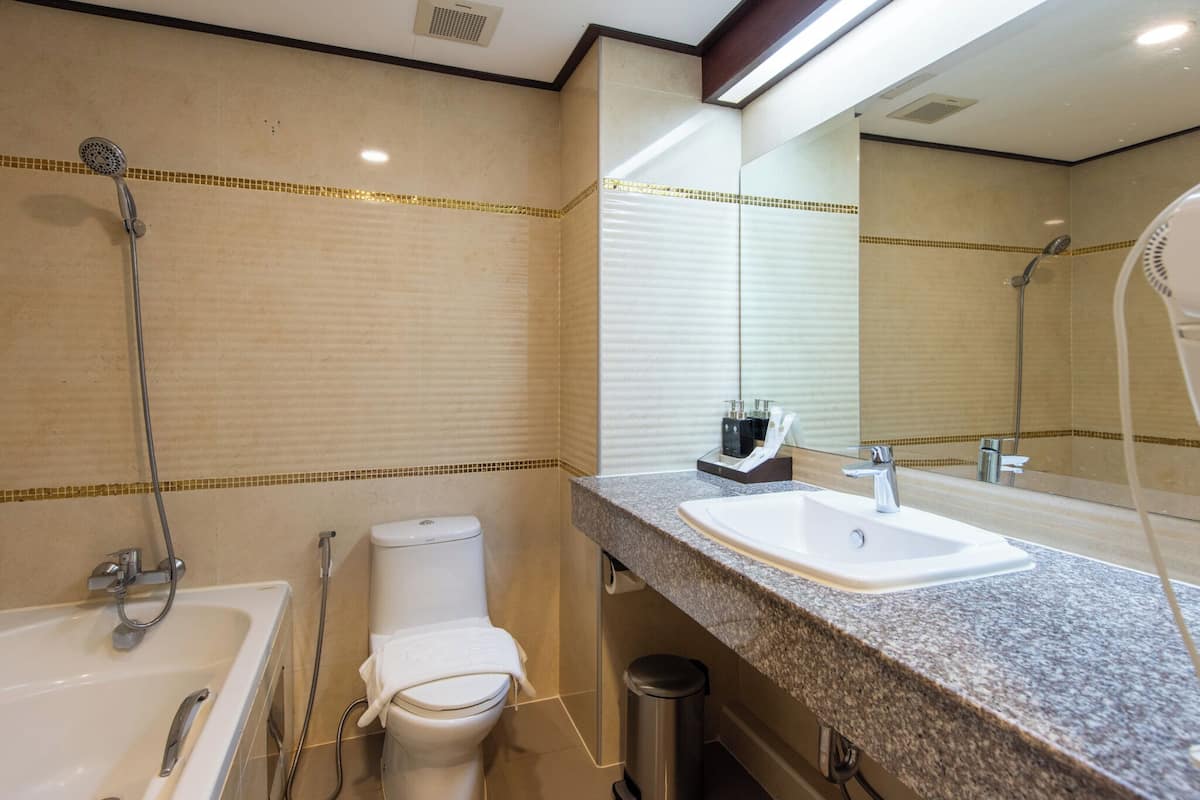 premier king room with bathtub | bathroom | free toiletries, hair dryer, slippers, towels