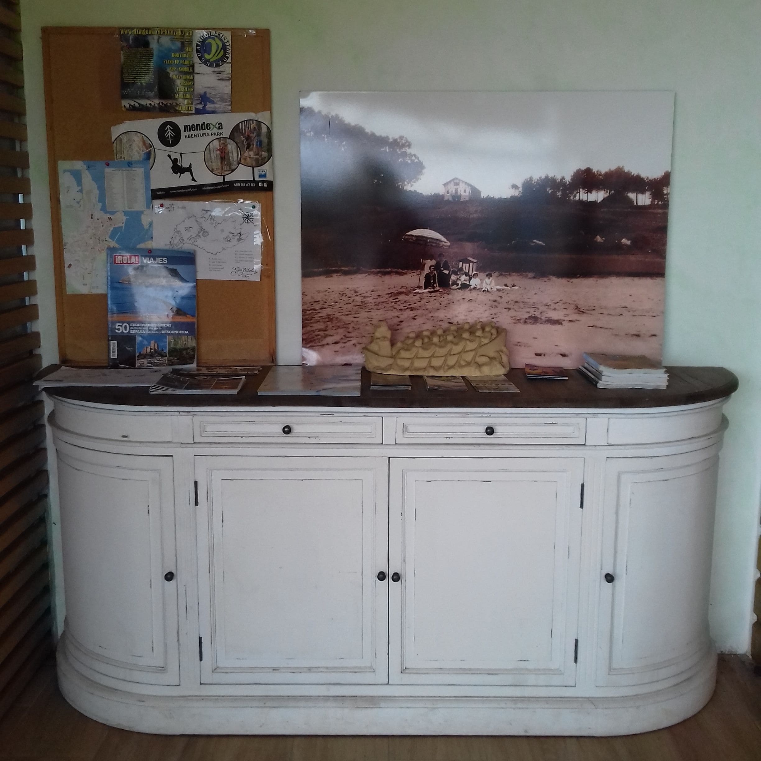 A white cabinet with two doors and a countertop.