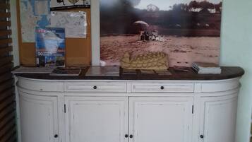 A white cabinet with two doors and a countertop.