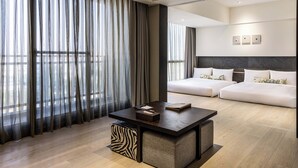 A modern hotel room with a large bed, a desk with a chair, and sheer curtains. - Hsin Hotel (Chiayi City)
