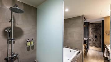 A modern bathroom with a shower, a bathtub, and a vanity.