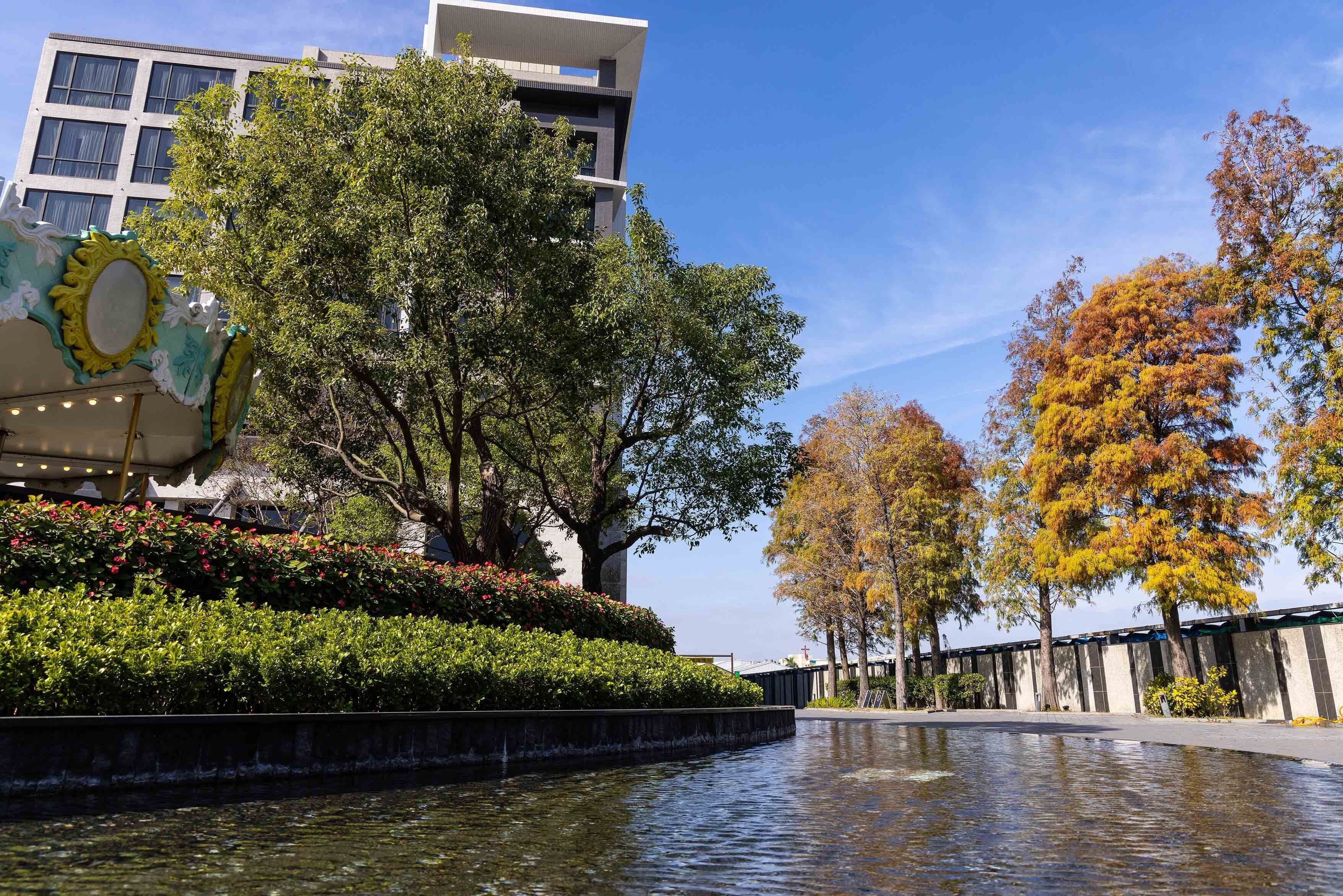 A modern building with a water feature in front.