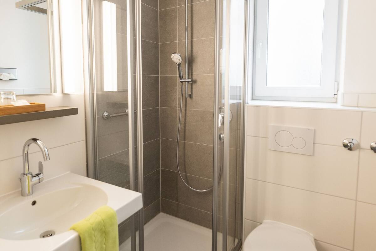standard single room | bathroom | shower, hair dryer, bathrobes, towels