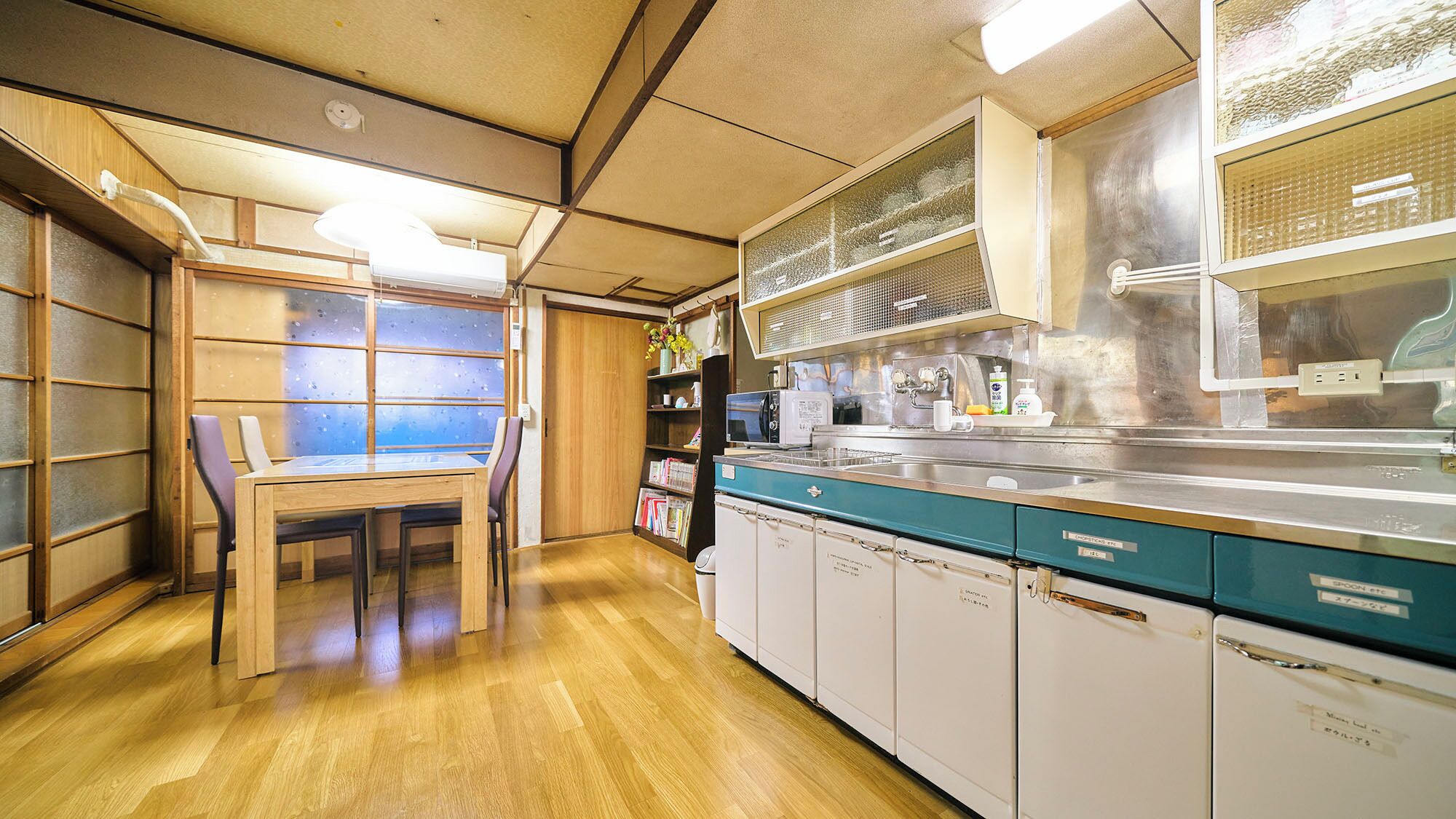 A kitchen with wooden cabinets, a microwave, and a sink.