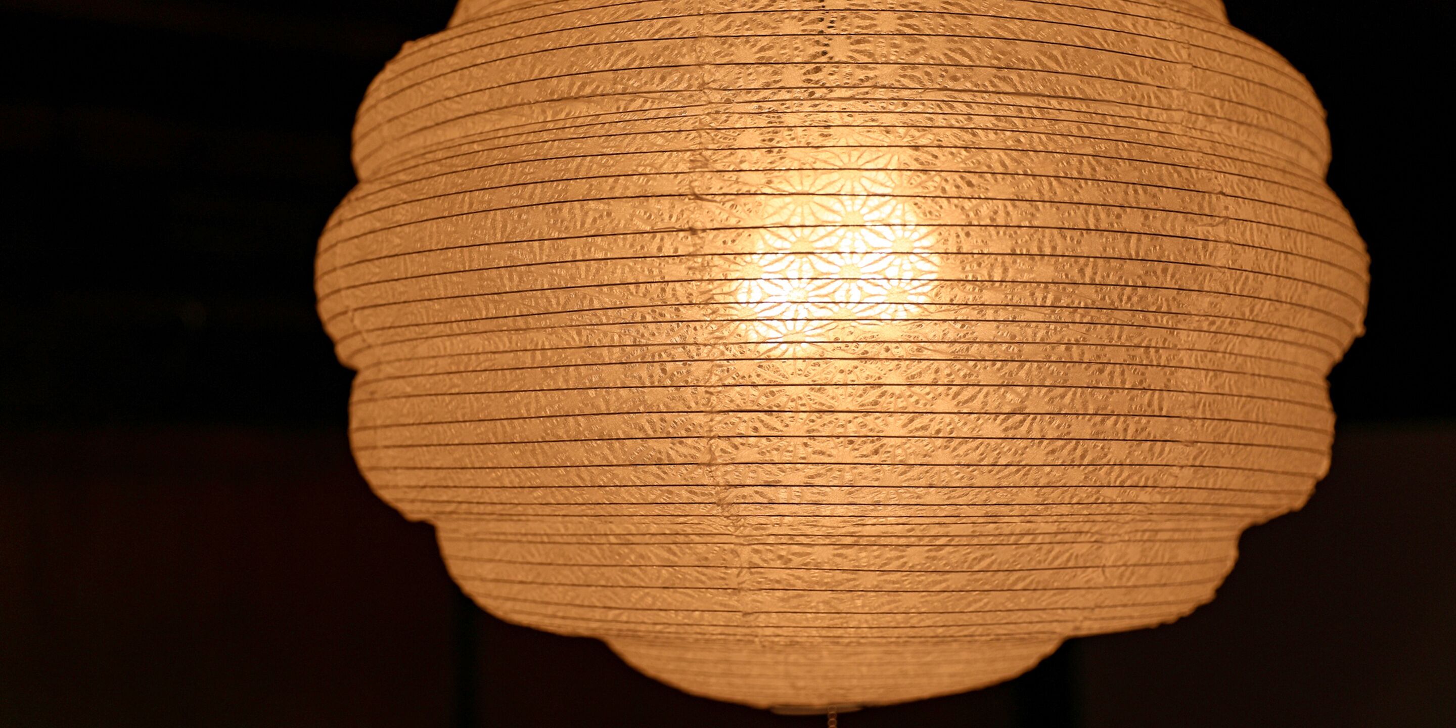 A close-up of a textured, cylindrical light fixture.