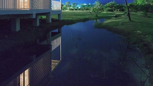 A house with a balcony overlooking a body of water, under a starry night sky. - Wild Island B&B (Hengchun)