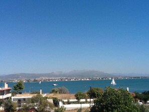 A coastal view with buildings, a clear sky, and sailboats on the water. - Petrospito Pool Apts Avlida, "Aeolos" (Chalcis)