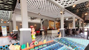 A colorful welcome sign with letters spelling "WELCOME" and a mosaic tile floor. - Grand Orchid Resort (Ko Chang)