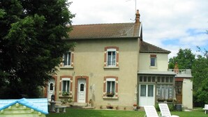 A two-story house with a large front lawn, a small playhouse, and outdoor seating. - La Coutrotte Becquine (Heuilley-sur-Saone)