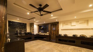 A modern kitchen with a central island, built-in appliances, and a ceiling fan. - La Savanna (Ramnagar)