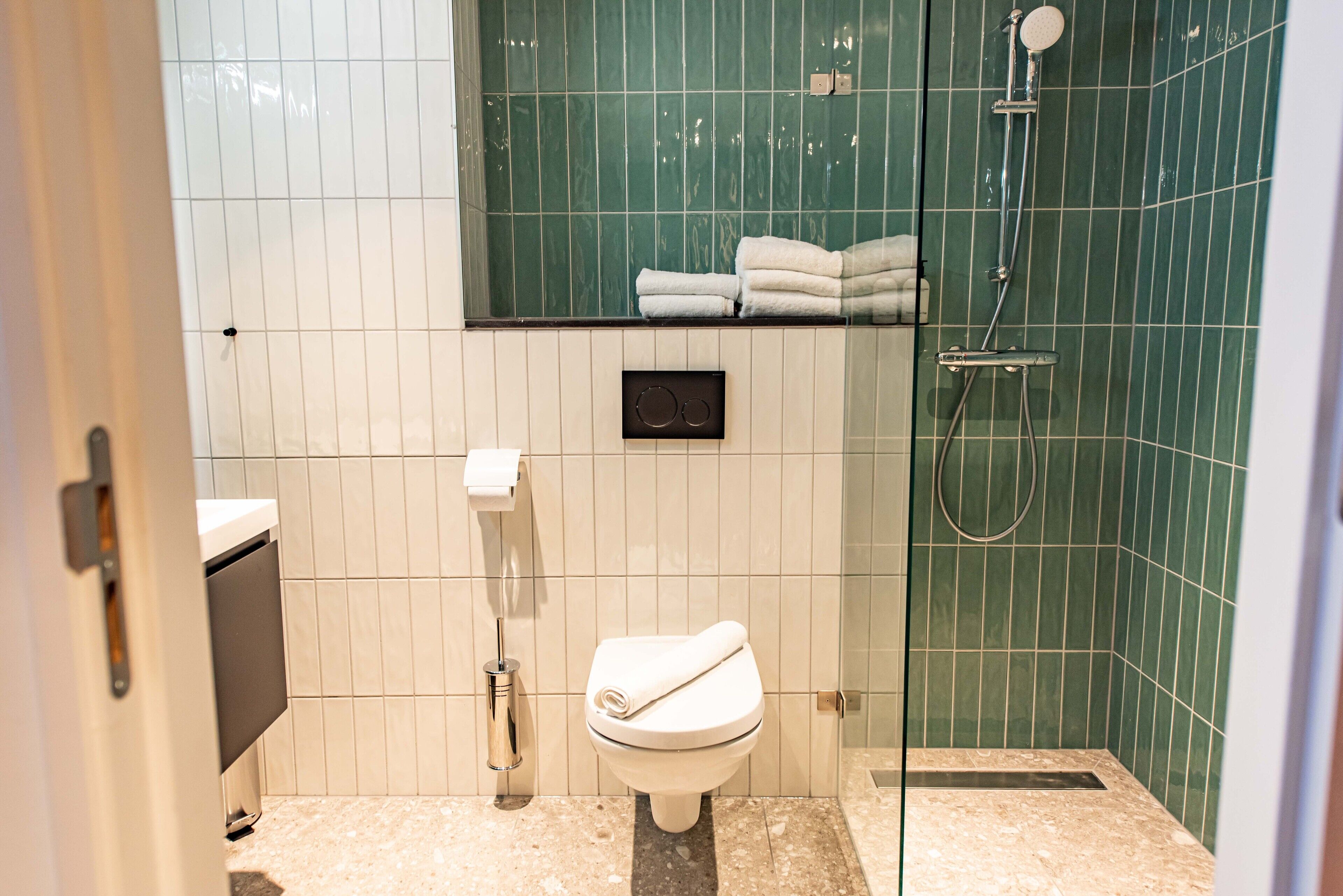 shower, designer toiletries, hair dryer, towels