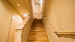 A wooden staircase with a handrail, leading to a door at the top. - Miro Sanjo Saiin Tei (Kyoto)